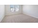 Cozy bedroom with plush carpeting, two windows, and neutral paint at 366 Tallulah Ln, Grayson, GA 30017