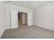 A neutrally decorated room that features carpet and an open doorway that leads to stairs at 366 Tallulah Ln, Grayson, GA 30017