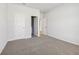 A bright bedroom with neutral walls and plush carpeting, with a view to other rooms at 366 Tallulah Ln, Grayson, GA 30017