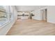 Open-concept living space with hardwood floors, large windows, and a modern kitchen at 366 Tallulah Ln, Grayson, GA 30017