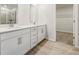 Bright bathroom featuring a double vanity, modern fixtures, and a view into the walk-in closet at 376 Tallulah Ln, Grayson, GA 30017