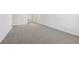 A spacious carpeted bedroom with neutral walls featuring a window and doorway at 376 Tallulah Ln, Grayson, GA 30017