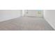 Large, carpeted bonus room featuring two windows allowing for ample natural light at 376 Tallulah Ln, Grayson, GA 30017