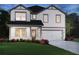 Charming two-story home features a two-car garage, landscaped yard and classic curb appeal at 376 Tallulah Ln, Grayson, GA 30017