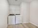Neat laundry room equipped with a washer, dryer, and wire shelving for storage at 376 Tallulah Ln, Grayson, GA 30017