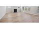Spacious living room with wood-look floors, a fireplace, and bright windows at 376 Tallulah Ln, Grayson, GA 30017
