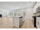 Open concept living space featuring a kitchen with stainless steel appliances and wood-look floors at 376 Tallulah Ln, Grayson, GA 30017