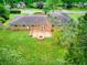 Large backyard with a stone patio and fire pit, perfect for gatherings and enjoying the outdoors in a serene setting at 4507 N Peachtree Rd, Dunwoody, GA 30338