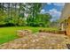 A backyard boasting a stone patio and a fire pit for outdoor enjoyment at 4507 N Peachtree Rd, Dunwoody, GA 30338