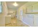 Spacious unfinished basement, featuring storage cabinets, a service door, and a window at 4507 N Peachtree Rd, Dunwoody, GA 30338