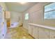Unfinished basement space with built in cabinets and large window providing plenty of light at 4507 N Peachtree Rd, Dunwoody, GA 30338