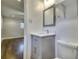 Clean bathroom featuring a modern vanity with a mirror and a toilet at 4507 N Peachtree Rd, Dunwoody, GA 30338