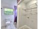 Full bathroom and laundry room area with washer hookups and purple accent wall at 4507 N Peachtree Rd, Dunwoody, GA 30338