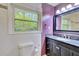 Well-lit bathroom with a black vanity, subway tile and toilet next to the window at 4507 N Peachtree Rd, Dunwoody, GA 30338