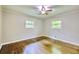 Bright bedroom featuring hardwood floors, neutral walls, and a ceiling fan at 4507 N Peachtree Rd, Dunwoody, GA 30338