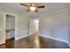 Bedroom with hardwood flooring, a closet, a ceiling fan and neutral walls at 4507 N Peachtree Rd, Dunwoody, GA 30338