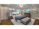 A light and airy bedroom with hardwood floors, neutral decor, and two windows at 4507 N Peachtree Rd, Dunwoody, GA 30338