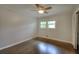 Bedroom boasting hardwood flooring, neutral paint, and a ceiling fan with light at 4507 N Peachtree Rd, Dunwoody, GA 30338