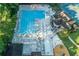Overhead view featuring a large community pool, surrounded by lounge chairs and umbrellas, next to a clubhouse and play area at 4507 N Peachtree Rd, Dunwoody, GA 30338