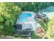 An aerial shot showcasing a large community pool, clubhouse, and playground surrounded by lush greenery, perfect for recreation at 4507 N Peachtree Rd, Dunwoody, GA 30338