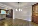 Dining room adjacent to kitchen with hardwood floors and classic built-in cabinetry at 4507 N Peachtree Rd, Dunwoody, GA 30338