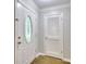 Inviting foyer with decorative front door, stylish hardwood floors, and access to a coat closet at 4507 N Peachtree Rd, Dunwoody, GA 30338