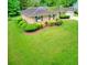 Well-maintained single story home with a spacious green front yard and mature bushes at 4507 N Peachtree Rd, Dunwoody, GA 30338