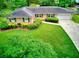 Inviting exterior view of single story brick home showcasing lush green lawn and beautiful shrubs at 4507 N Peachtree Rd, Dunwoody, GA 30338