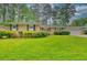Charming brick home with well-manicured lawn and mature landscaping with blue shutters at 4507 N Peachtree Rd, Dunwoody, GA 30338