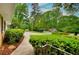 Beautifully landscaped front yard with lush greenery and a sidewalk leading to the home at 4507 N Peachtree Rd, Dunwoody, GA 30338