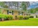 Charming brick home with well-manicured lawn and mature landscaping with blue shutters at 4507 N Peachtree Rd, Dunwoody, GA 30338