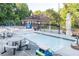 A wonderful kiddie pool and clubhouse area featuring tables, benches, and a playground nearby at 4507 N Peachtree Rd, Dunwoody, GA 30338