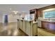 Kitchen has a spacious island, stainless steel appliances, and a view into the living room at 4507 N Peachtree Rd, Dunwoody, GA 30338