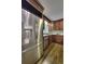 A kitchen featuring stainless steel refrigerator, wooden cabinets, and a sink under a window at 4507 N Peachtree Rd, Dunwoody, GA 30338