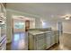 A kitchen island with granite counters and a built-in cooktop, flowing into the living areas at 4507 N Peachtree Rd, Dunwoody, GA 30338