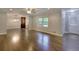 Spacious living room with hardwood floors, neutral colors, and an adjacent dining area at 4507 N Peachtree Rd, Dunwoody, GA 30338
