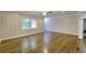 Open-concept living room featuring hardwood floors, neutral paint, and a ceiling fan at 4507 N Peachtree Rd, Dunwoody, GA 30338