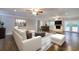Nicely staged living room with hardwood floors, a ceiling fan and a fireplace for cozy evenings at 4507 N Peachtree Rd, Dunwoody, GA 30338