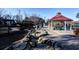 A beautiful community park features a rock-lined path leading to a covered picnic area and playground at 4507 N Peachtree Rd, Dunwoody, GA 30338