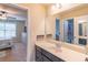 This bathroom features a vanity, a large mirror, and a view into the bedroom at 486 Raven Brook Ln, Suwanee, GA 30024