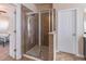 Modern bathroom featuring a glass-enclosed shower, and neutral tile finishes at 486 Raven Brook Ln, Suwanee, GA 30024