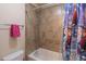 This bathroom features a shower and tub combination with a ceramic tile surround at 486 Raven Brook Ln, Suwanee, GA 30024