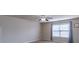 An airy bedroom with natural light and a ceiling fan at 486 Raven Brook Ln, Suwanee, GA 30024