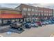 Shops and dining locations at Suwanee Town Center, with parallel parking in front of the buildings at 486 Raven Brook Ln, Suwanee, GA 30024