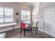 Cozy dining area with a glass table, colorful chairs, and natural light from nearby windows at 486 Raven Brook Ln, Suwanee, GA 30024