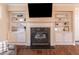 Charming fireplace with built-in shelving, creating a focal point in the inviting and warm living space at 486 Raven Brook Ln, Suwanee, GA 30024
