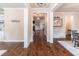 Spacious hallway with hardwood floors, white trim and decorative accents leading to other living areas at 486 Raven Brook Ln, Suwanee, GA 30024