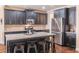 Modern kitchen featuring dark cabinets, granite counters, stainless steel appliances and a convenient center island at 486 Raven Brook Ln, Suwanee, GA 30024
