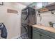 Laundry room with stackable washer and dryer, and built-in cabinets at 486 Raven Brook Ln, Suwanee, GA 30024