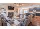 Open-concept living room featuring hardwood floors, a fireplace, kitchen access and comfortable seating at 486 Raven Brook Ln, Suwanee, GA 30024